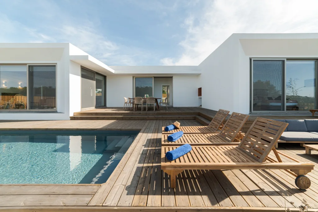 Lounge chairs in modern villa pool
